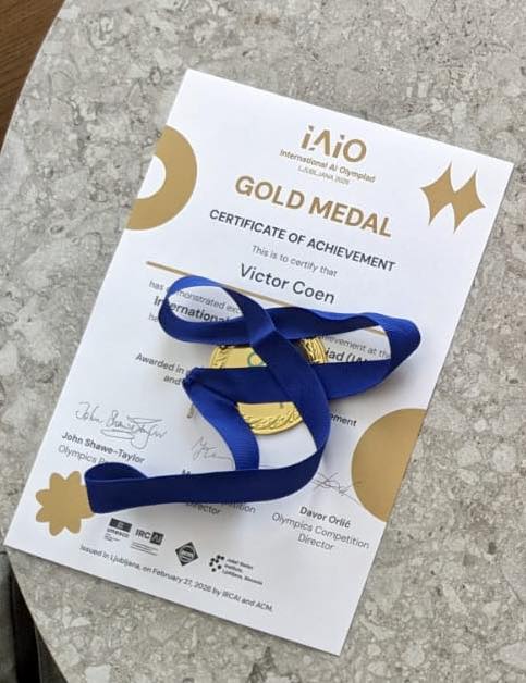 Victor with his certificate of accomplishment and gold medal